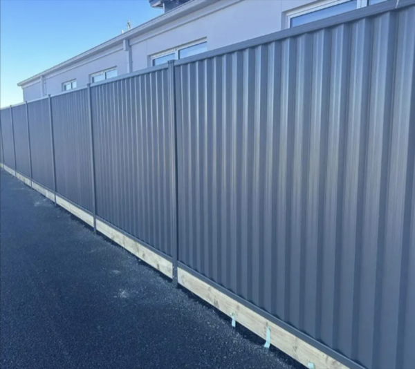 a long Colorbond fence running beside a footpath