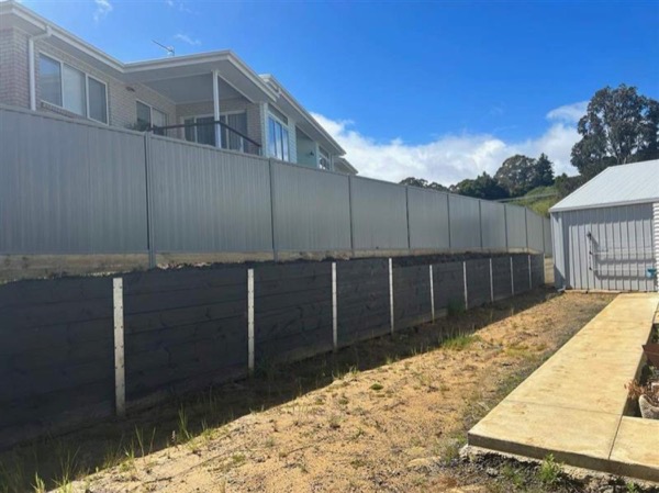 a long Colorbond fence run behind a house